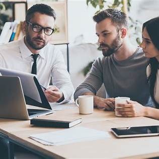 [Image of person with tablet reviewing documents]
